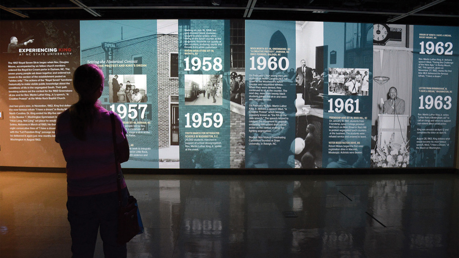 A silhouetted person views an interactive exhibit about Martin Luther King Jr.