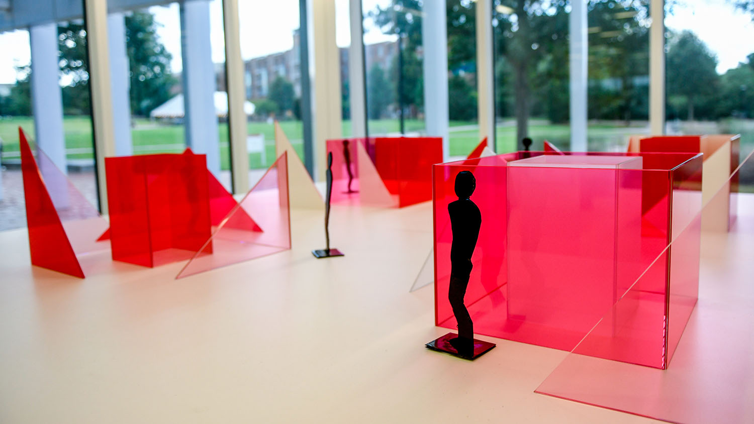Photo features a maquette of artist Larry Bell's "Reds and Whites" installation slated for Centennial Campus, featuring red and white sculptural blocks, in the lobby of Hunt Library.
