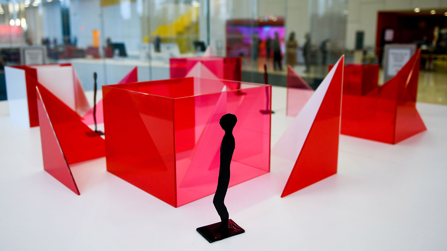 Photo features a maquette of artist Larry Bell's "Reds and Whites" installation slated for Centennial Campus, featuring red and white sculptural blocks, in the lobby of Hunt Library.