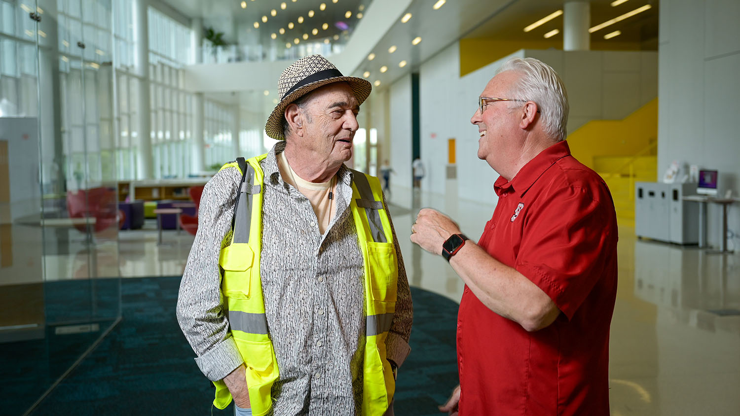Artist Larry Bell and NC State Chancellor Randy Woodson share a laugh in the lobby of Hunt Library.