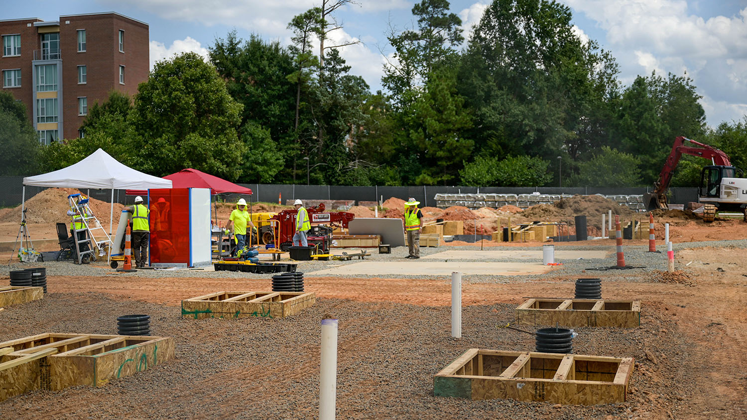 The first piece of Larry Bell's artwork, Reds and Whites, is installed in a plaza under construction outside the east entrance of Hunt Library.